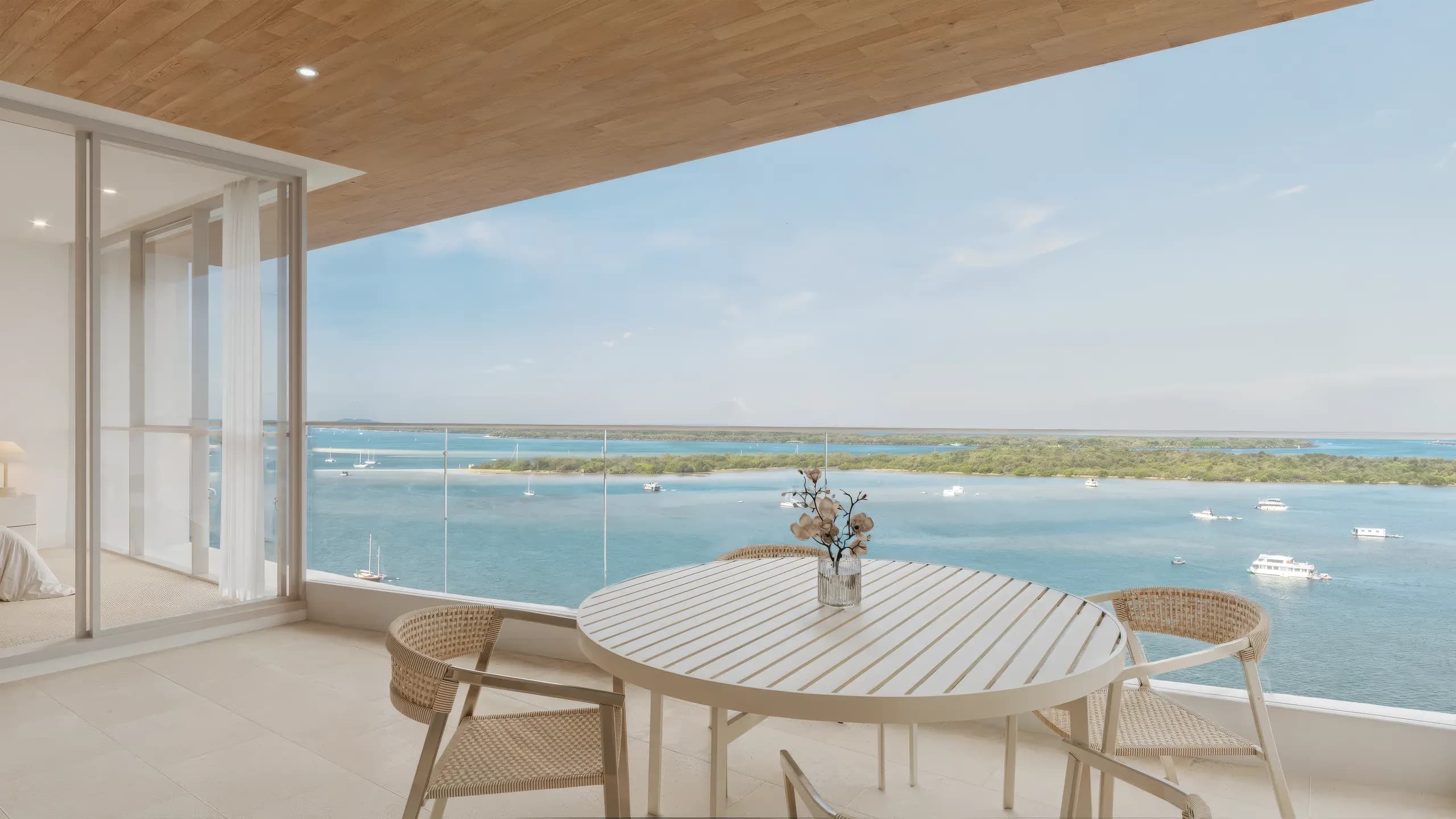 Balcony with a table overlooking the water