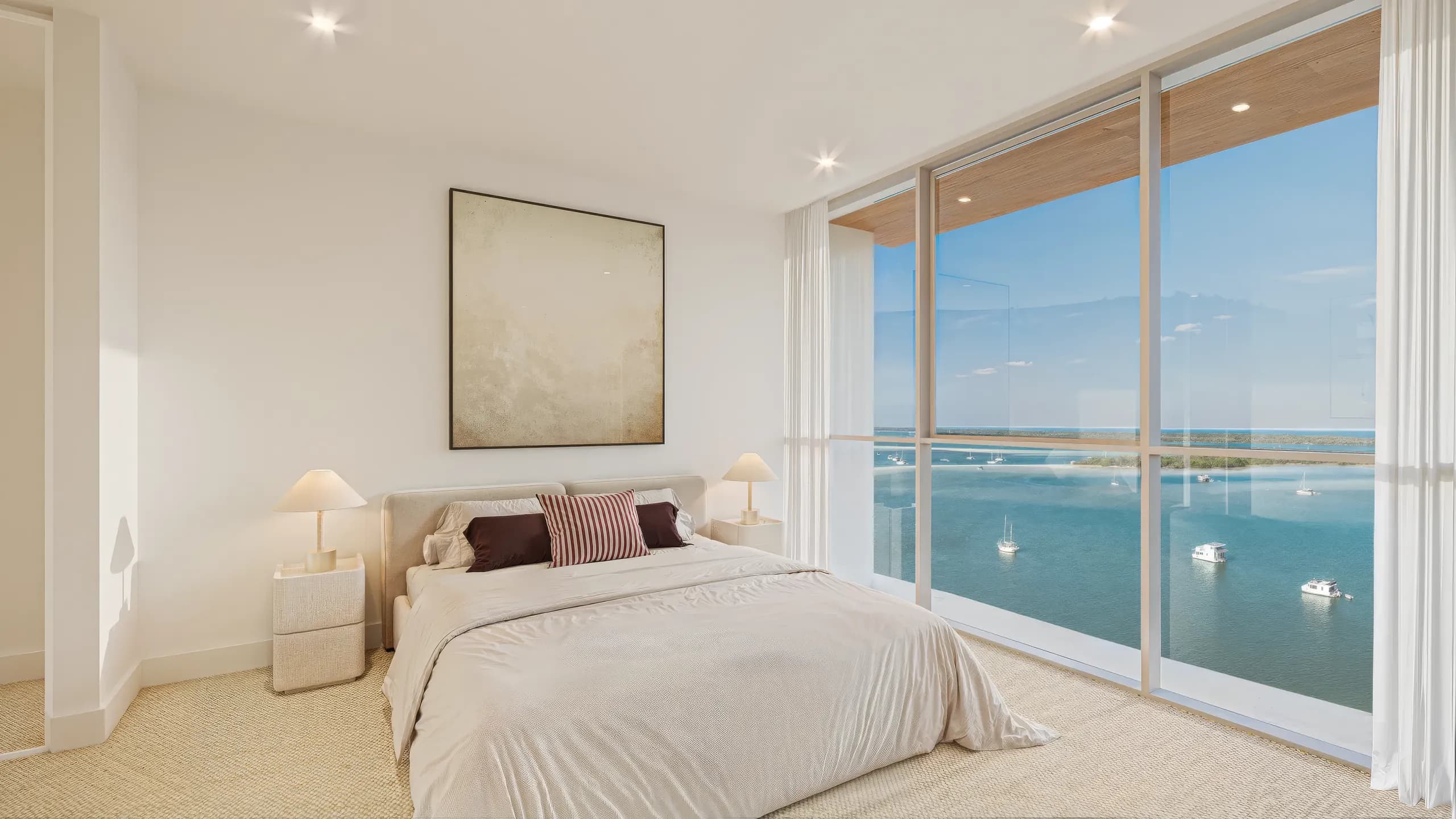 Bedroom with full-height glazing to the water