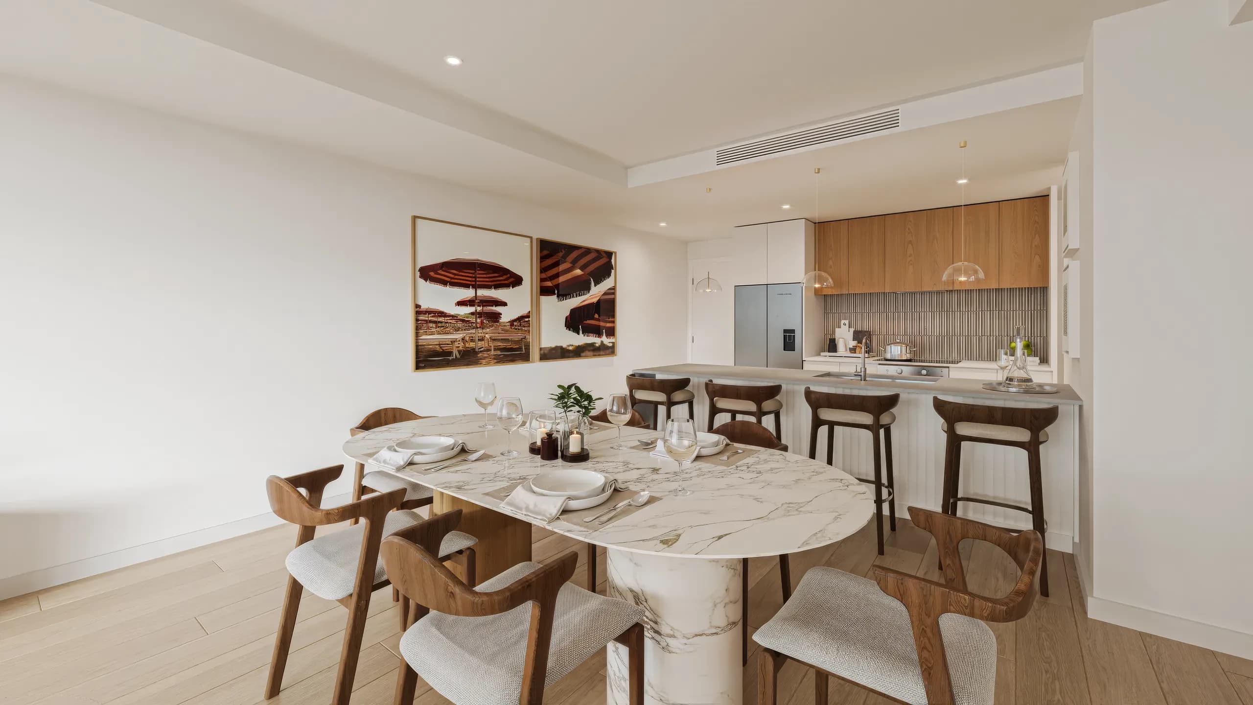 Marble dining table and timber kitchen in a bright apartment