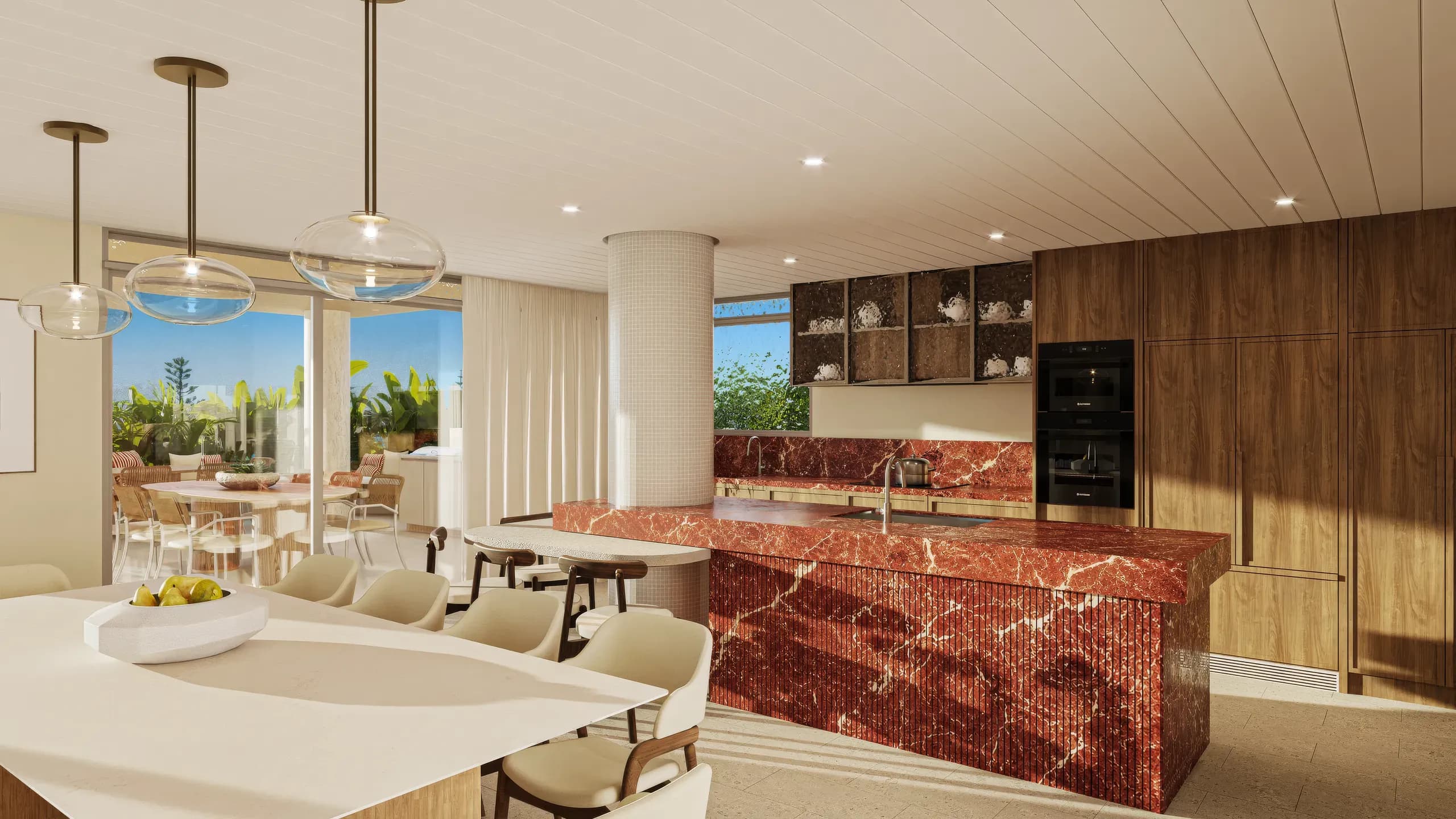 Kitchen with a red marble island under pendant lights