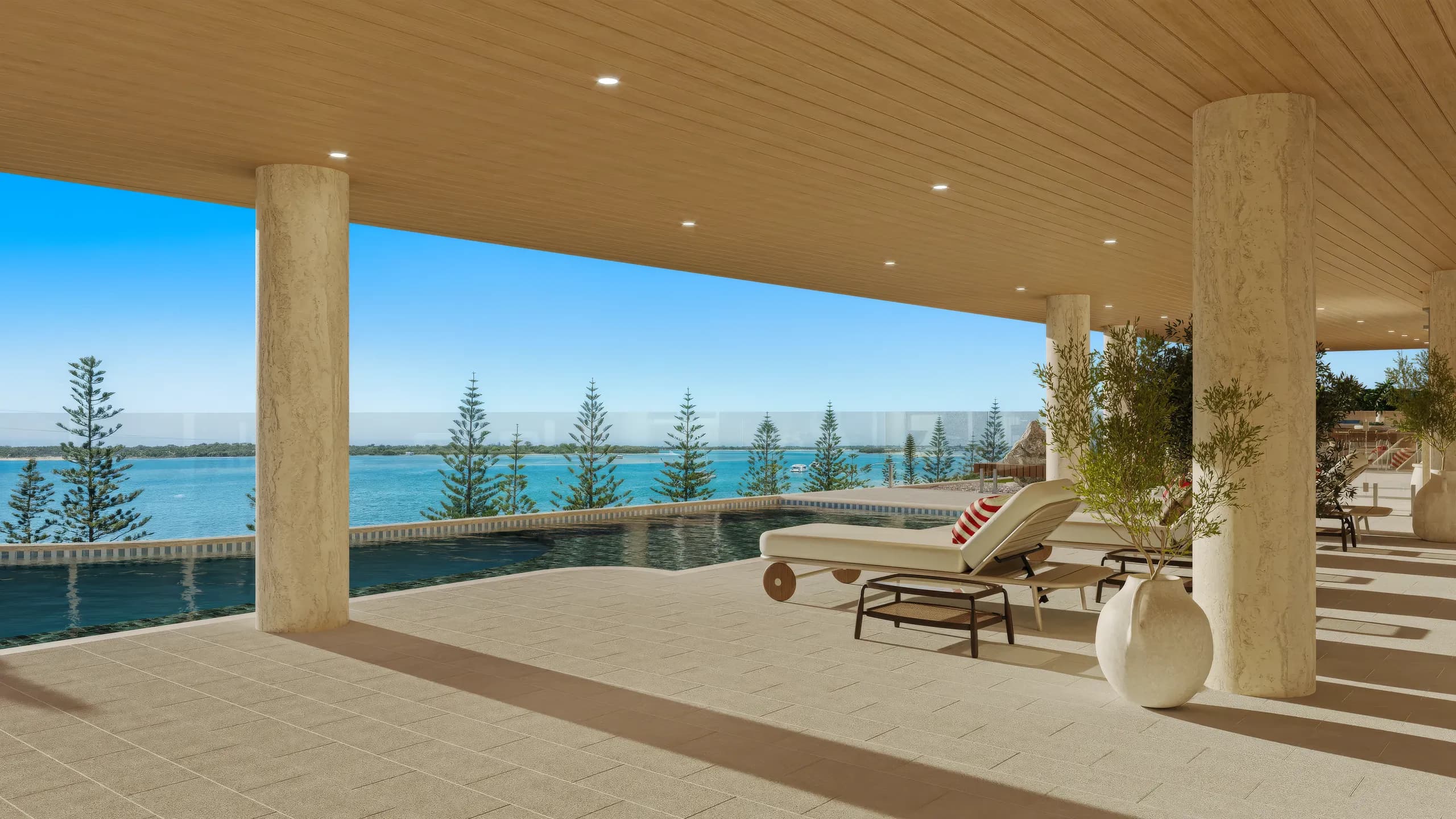 Pool deck with loungers under a timber-lined soffit facing the sea